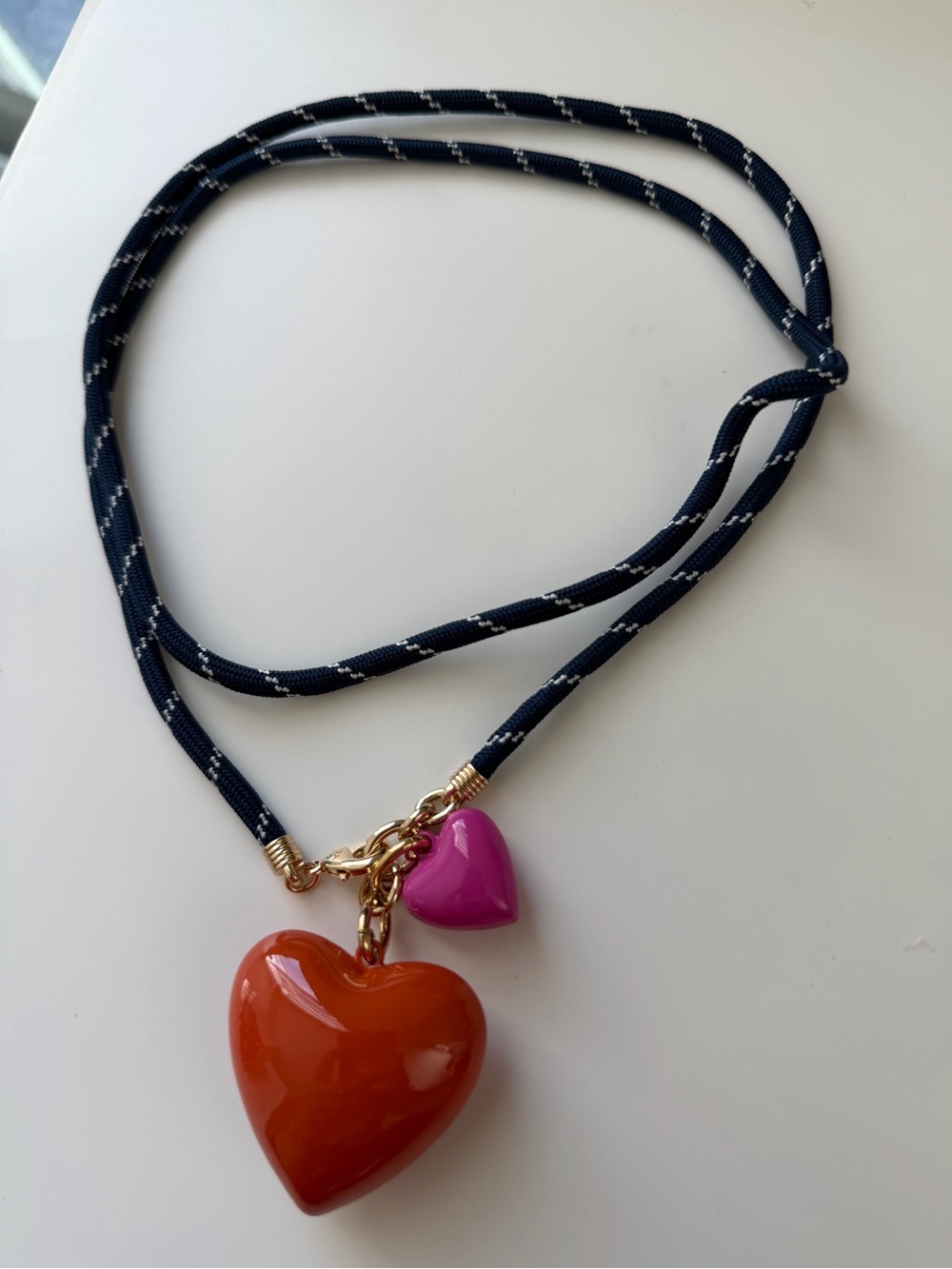 NWOT Roxanne Assoulin Navy Cord Necklace with Orange and Pink Heart Charms